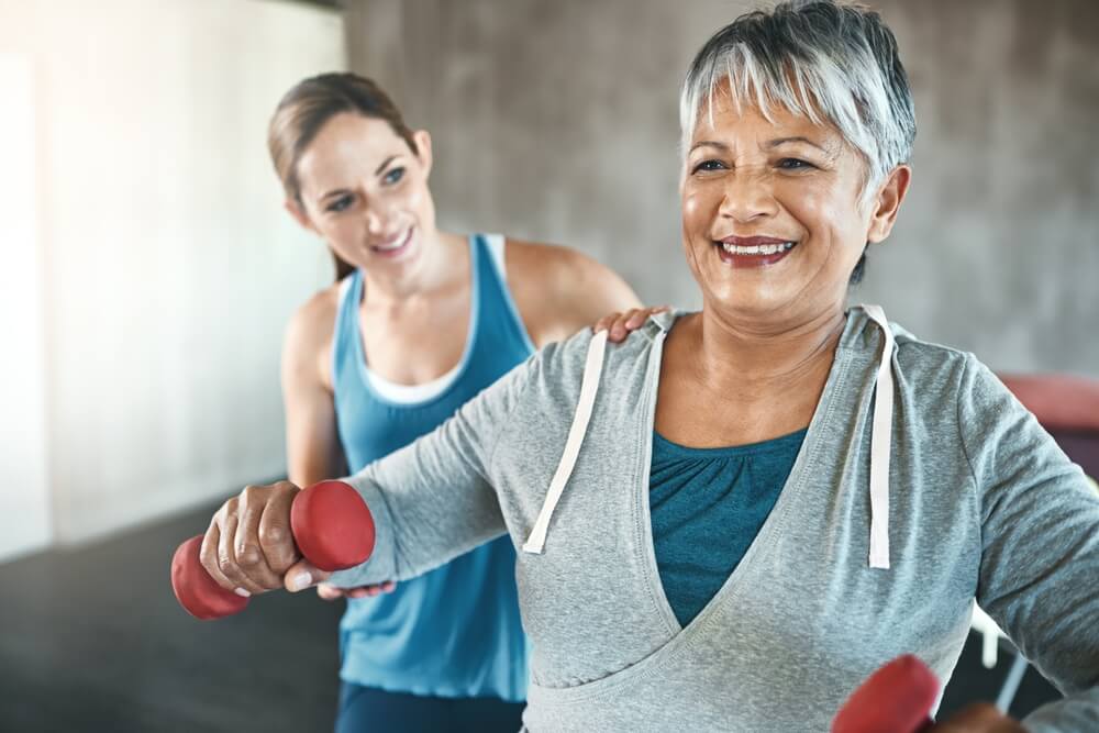 Older adult doing strength training with dumbbells.