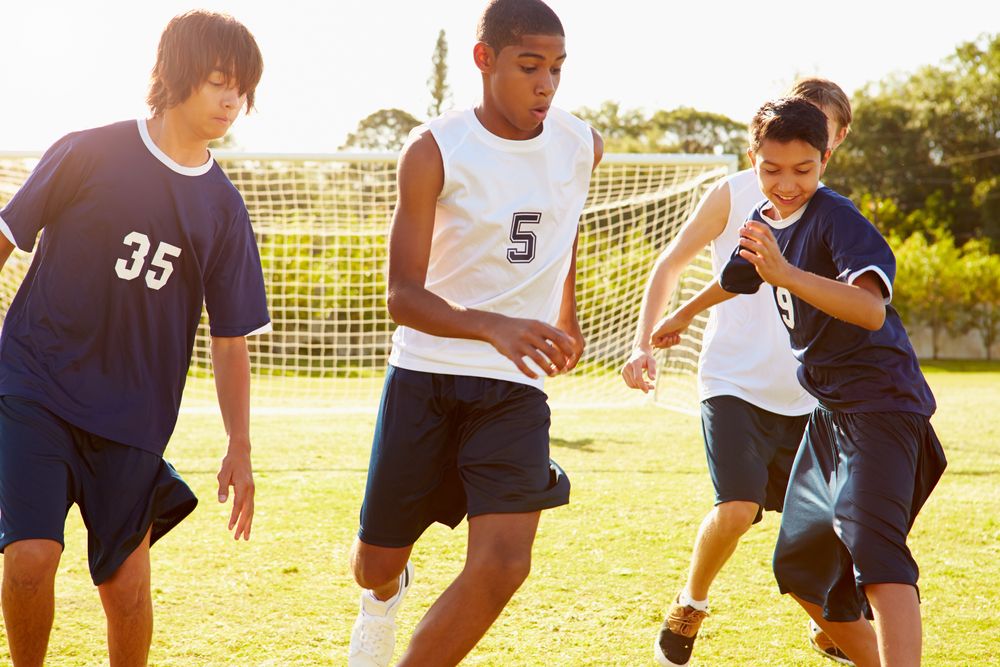 Soccer players on the field, sports injury prevention concept.