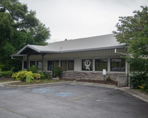 Exterior of a Dosher Physical Therapy clinic with parking area.